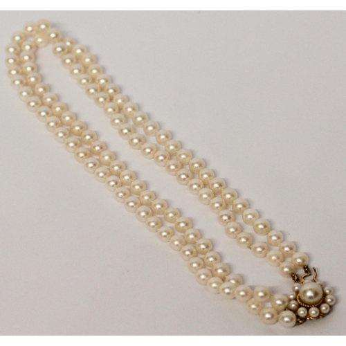 645 - A cultured pearl choker necklace, comprised of a double row of pearls to a 9ct gold circular pearl c... 