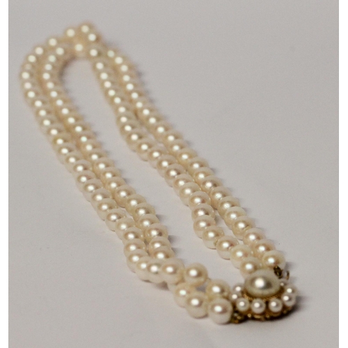 645 - A cultured pearl choker necklace, comprised of a double row of pearls to a 9ct gold circular pearl c... 