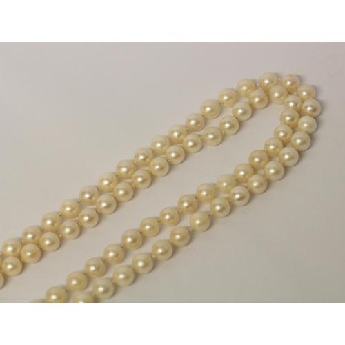 646 - A double uniform row of cultured pearls to a white gold sapphire and diamond circular cluster clasp.... 