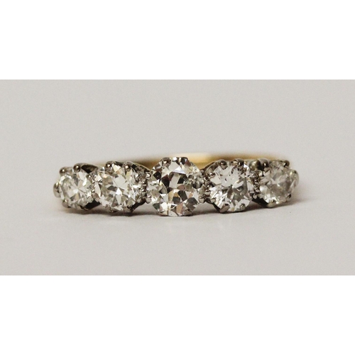 692 - A vintage five stone diamond ring of graduated brilliant cut diamonds, on unmarked yellow gold shank... 