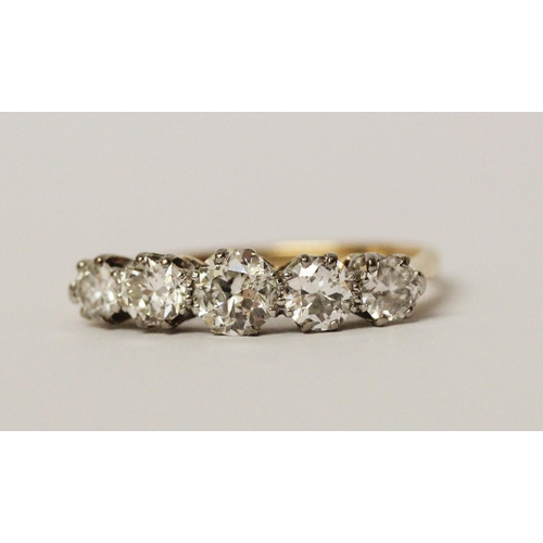 692 - A vintage five stone diamond ring of graduated brilliant cut diamonds, on unmarked yellow gold shank... 