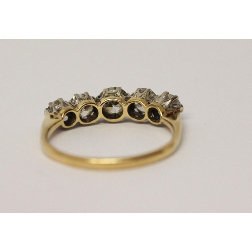 692 - A vintage five stone diamond ring of graduated brilliant cut diamonds, on unmarked yellow gold shank... 