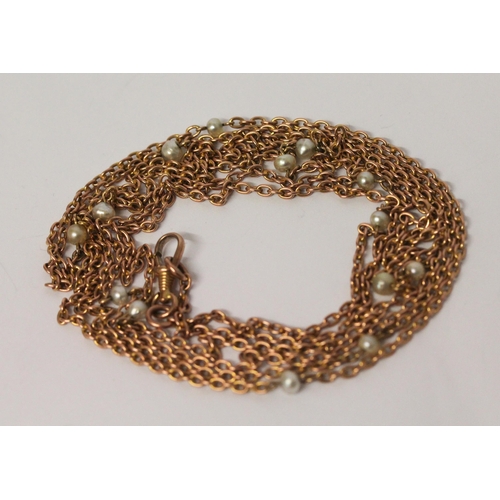 694 - A Victorian rose gold long guard chain, set with freshwater pearls, marked 9c to clasp, 150 cms long... 