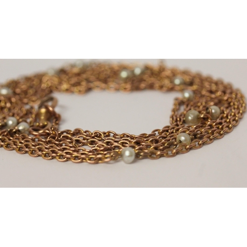 694 - A Victorian rose gold long guard chain, set with freshwater pearls, marked 9c to clasp, 150 cms long... 