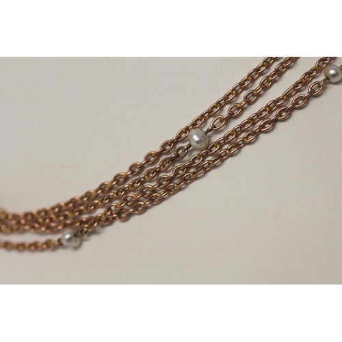 694 - A Victorian rose gold long guard chain, set with freshwater pearls, marked 9c to clasp, 150 cms long... 