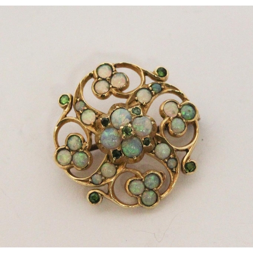 703 - An Edwardian opal and emerald brooch, in unmarked yellow gold. 26mm across. Gross weight 6 grams.