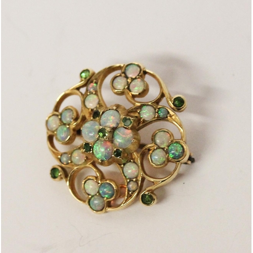 703 - An Edwardian opal and emerald brooch, in unmarked yellow gold. 26mm across. Gross weight 6 grams.