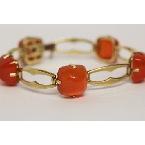 709 - A Victorian 15ct yellow gold carnelian bracelet, set with five domed cabochons on openwork gold link... 