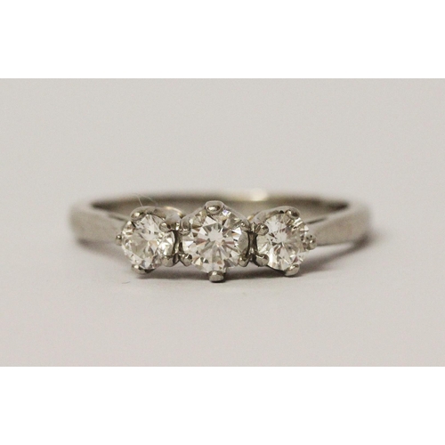 718 - A platinum and diamond three stone ring, with three brilliant cut graduated diamonds in claw setting... 