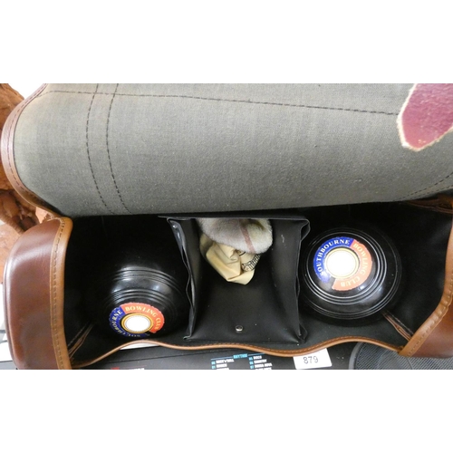 877 - A brown leather carrying case containing a set of four Crown Green bowling balls