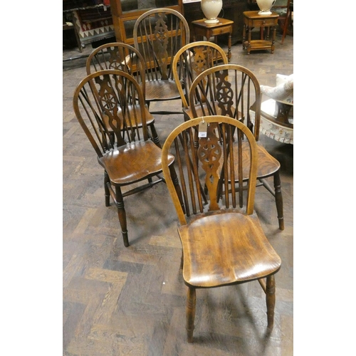 481 - Five wheel back Windsor chairs with stretcher bases and one similar carver. (6)