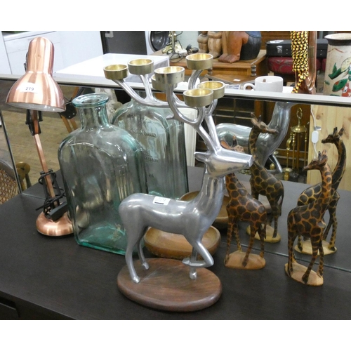 219 - Angle poise desk lamp, deer candelabra, carved giraffes, large glass bottle etc