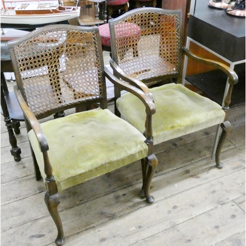 220 - A pair of small oak framed elbow chairs with cane panelled back and upholstered seats