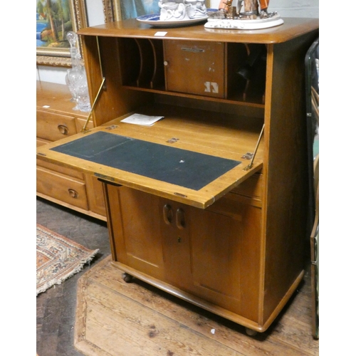 240 - A light elm Ercol style bureau cabinet with flap, drawer and cupboards under, 32