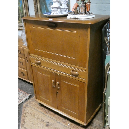 240 - A light elm Ercol style bureau cabinet with flap, drawer and cupboards under, 32