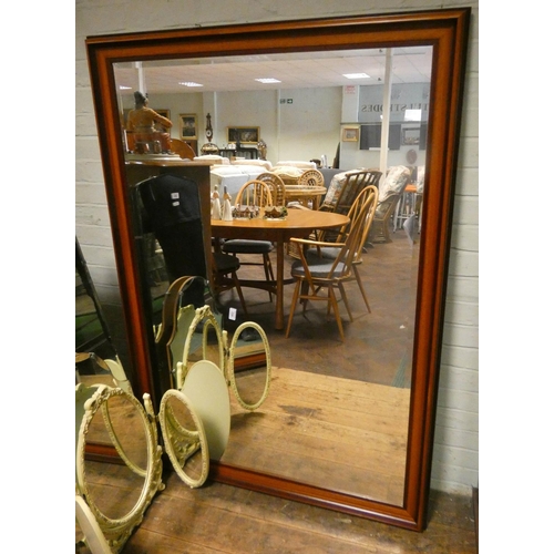 256 - A very large bevelled wall mirror in a mahogany frame