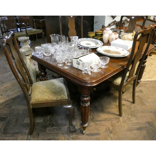 259 - A late Victorian mahogany extending dining table on reeded legs with centre leaf and a set of four h... 