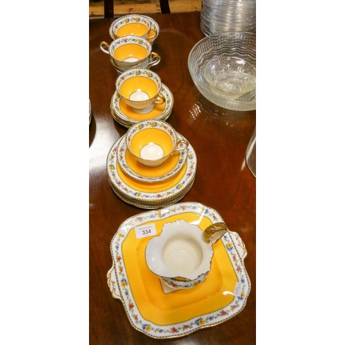 334 - An Aynsley vintage part tea service decorated in Ochre yellow and flower border