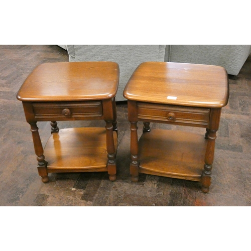 243 - A pair of Ercol Golden Dawn two tier bedside or lamp tables, each fitted one drawer