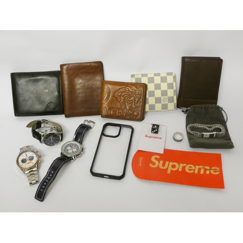 819 - A small collection of designer men's watches and wallets, Supreme dice etc all contained within a sm... 