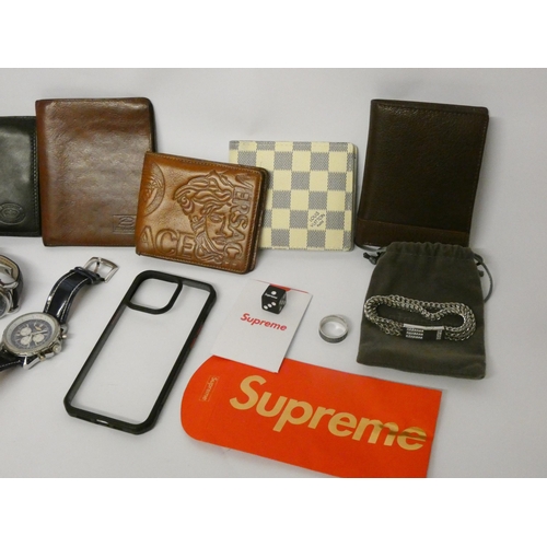 819 - A small collection of designer men's watches and wallets, Supreme dice etc all contained within a sm... 