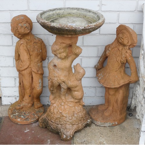 984 - A pair of terracotta male and female garden figures and a terracotta garden bird bath