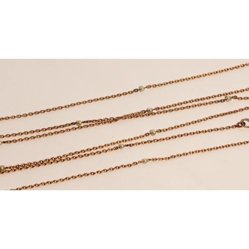 694 - A Victorian rose gold long guard chain, set with freshwater pearls, marked 9c to clasp, 150 cms long... 