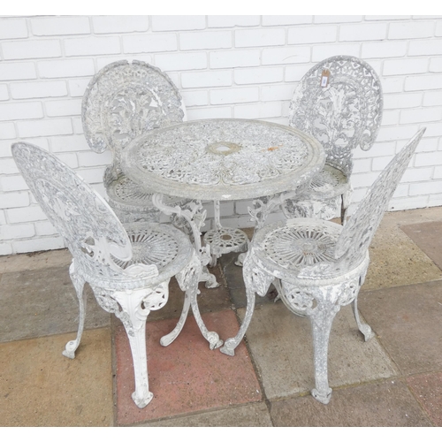 985 - A metal circular garden table together with four matching chairs