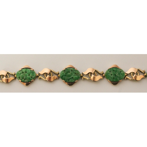 736 - A Chinese gold and carved jade panel bracelet, 18.5 cms long, Chinese character marks to clasp. Gros... 