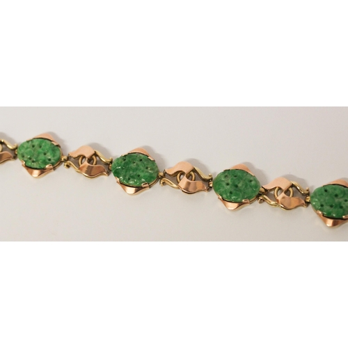 736 - A Chinese gold and carved jade panel bracelet, 18.5 cms long, Chinese character marks to clasp. Gros... 