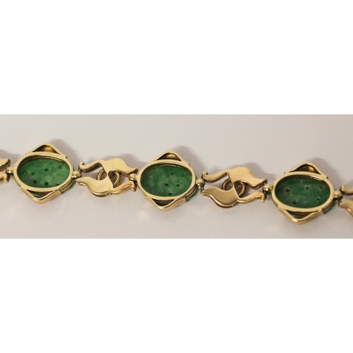 736 - A Chinese gold and carved jade panel bracelet, 18.5 cms long, Chinese character marks to clasp. Gros... 