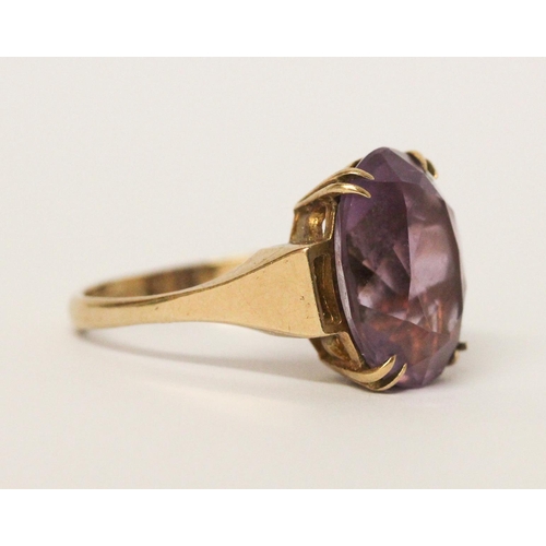 739 - An amethyst single stone ring, claw set with a large oval amethyst on hallmarked 9ct gold band. 5 gr... 