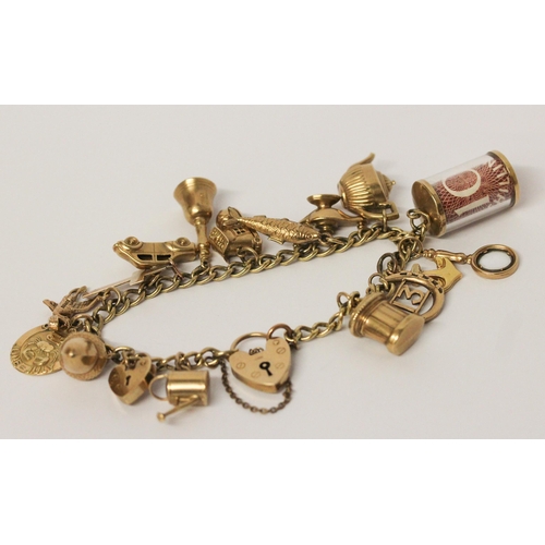 740 - A vintage 9ct yellow gold charm bracelet, set 17 charms including old £10 note, with hallmarked hear... 