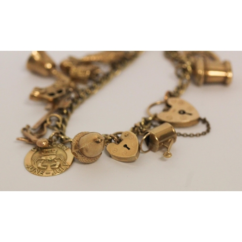 740 - A vintage 9ct yellow gold charm bracelet, set 17 charms including old £10 note, with hallmarked hear... 