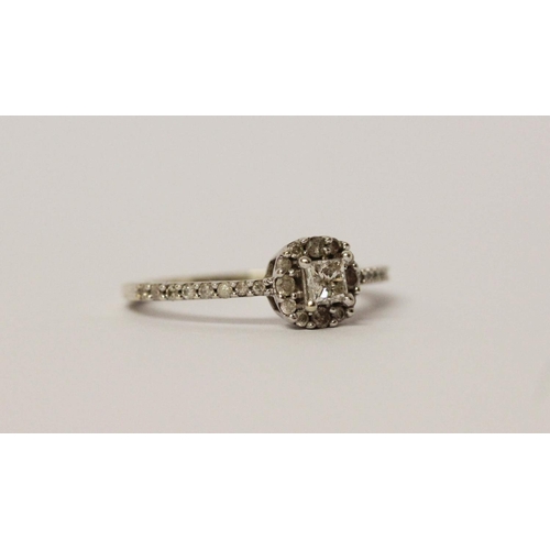 571 - A modern diamond cluster ring, on diamond set shoulders in 9ct white gold. Hallmarked, ring size M