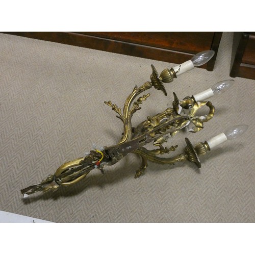 302 - A pair of early 20th century gilt brass three branch wall sconces, wired for electricity, overall le... 