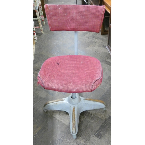 106 - A heavy industrial style revolving office chair with red upholstered seat and back