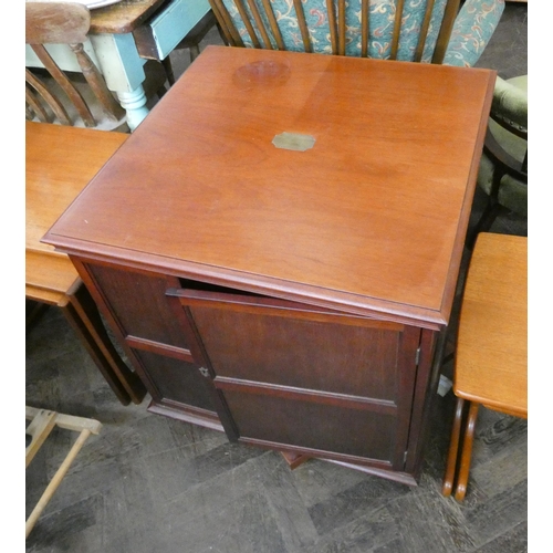 119 - A square mahogany revolving book table, fitted cupboards, 2' square