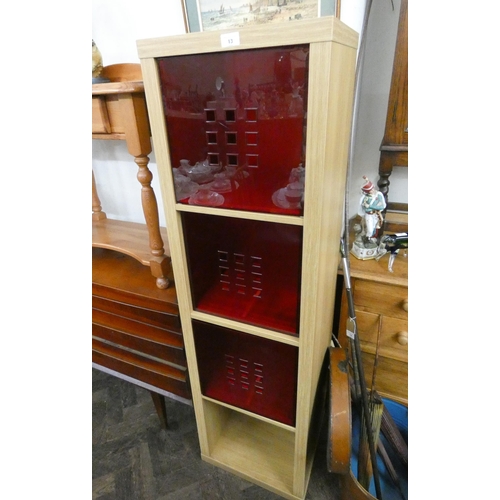 13 - A modern light oak finished storage cabinet with three red plastic pull out drawers