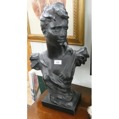 134 - A black plaster bust of a young lady, 22