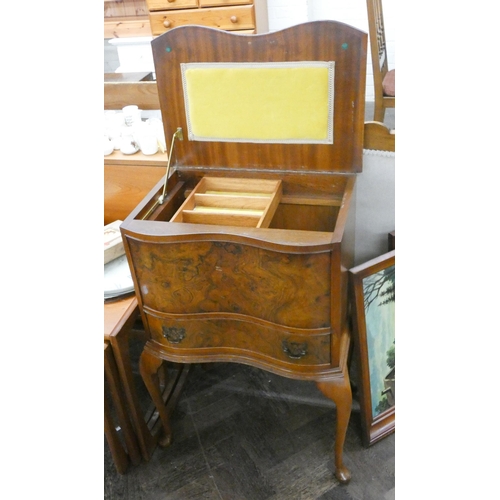 168 - A figured walnut serpentine front lift top workbox, fitted drawer on cabriole legs