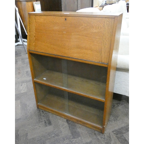 180 - A students oak bureau with sliding glass doors under