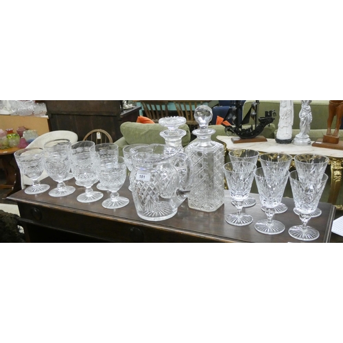 181 - A cut glass water jug with eight matching glasses, two decanters and six wine glasses