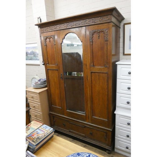 194 - A 1930's oak wardrobe with mirror drawer and drawer under, 4' wide