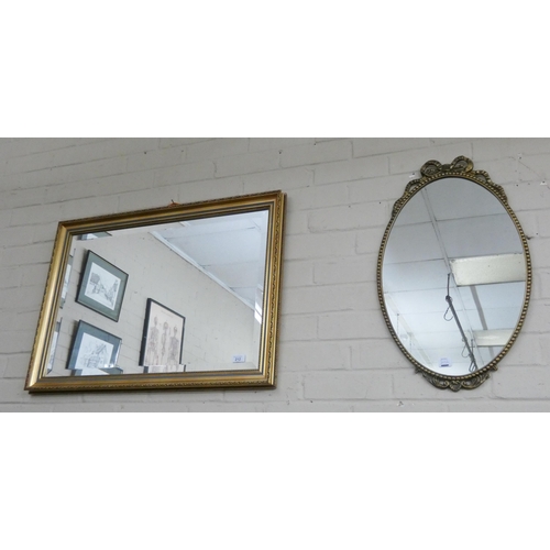 212 - A bevelled wall mirror in gilt frame and an oval gilt framed mirror