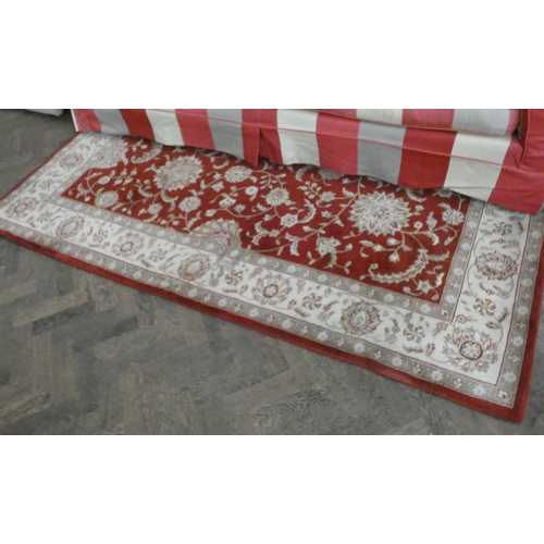 240 - A pair of large red and fawn pattern rugs each 7'6 X 5'6 approximately