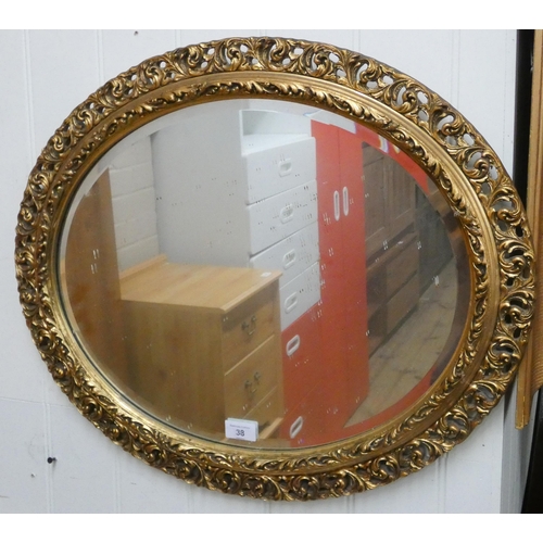 38 - Oval bevelled wall mirror in decorative gilt frame