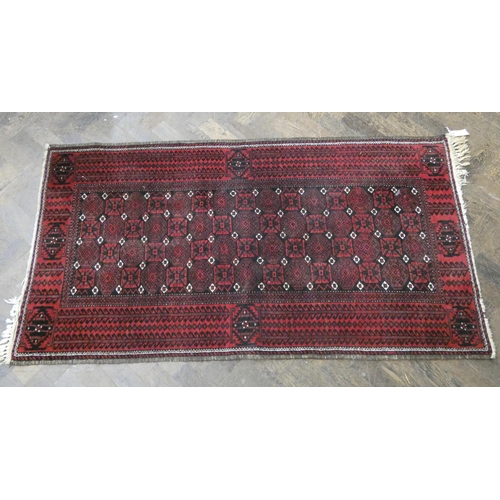 51 - A red and patterned wool pile Persian design rug