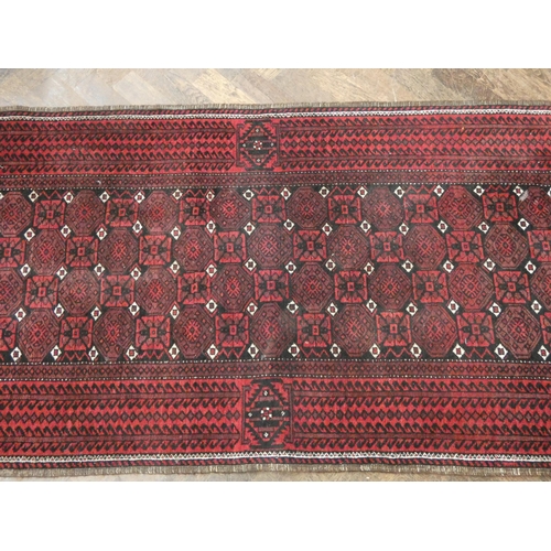 51 - A red and patterned wool pile Persian design rug