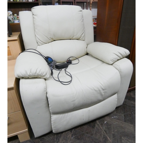 65 - An electrically heated and reclining easy chair in cream leather